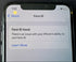Phone screen showing Face ID issue message on a dark textured background