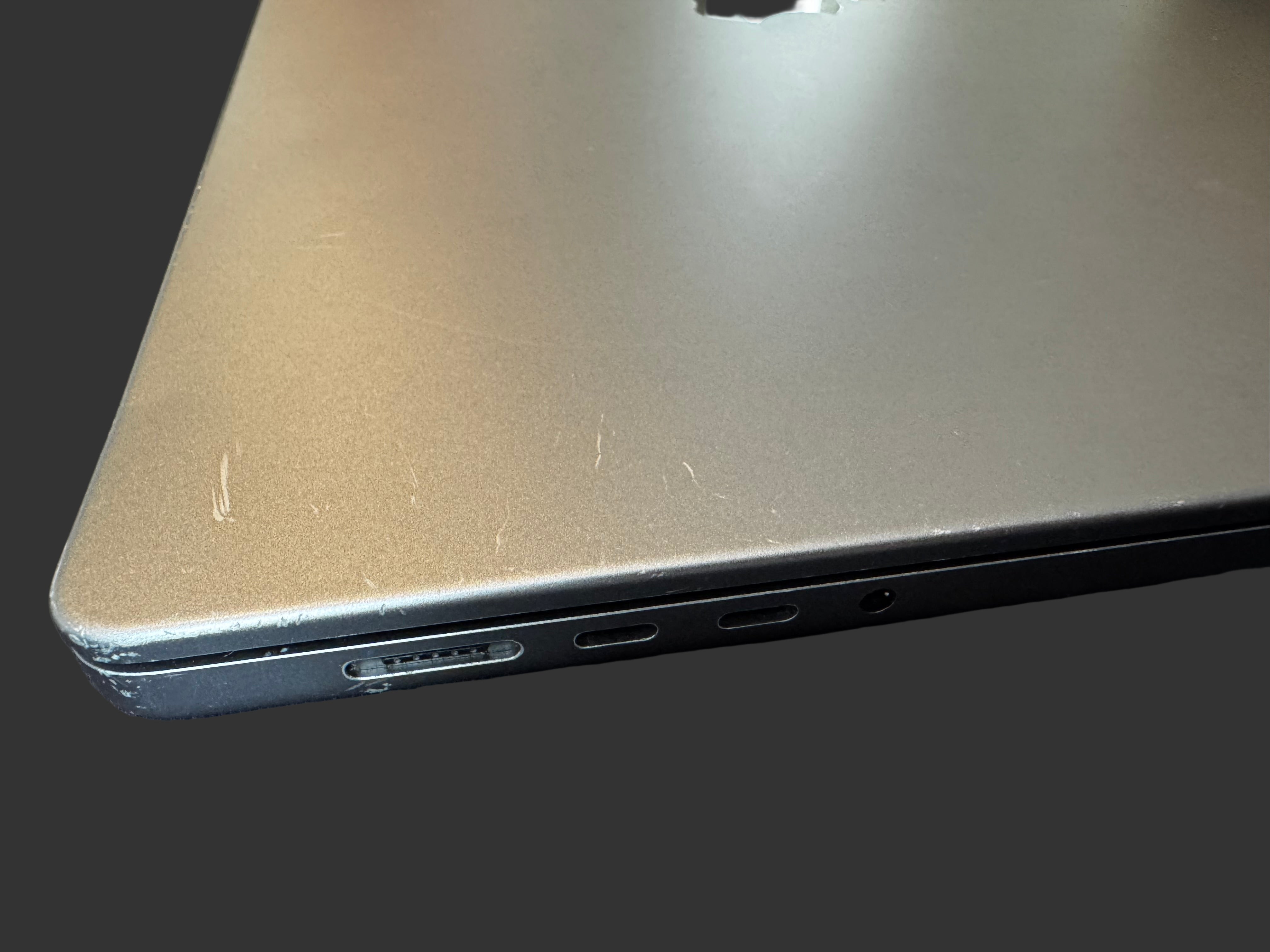 Close-up of a laptop's side view with ports on a dark surface